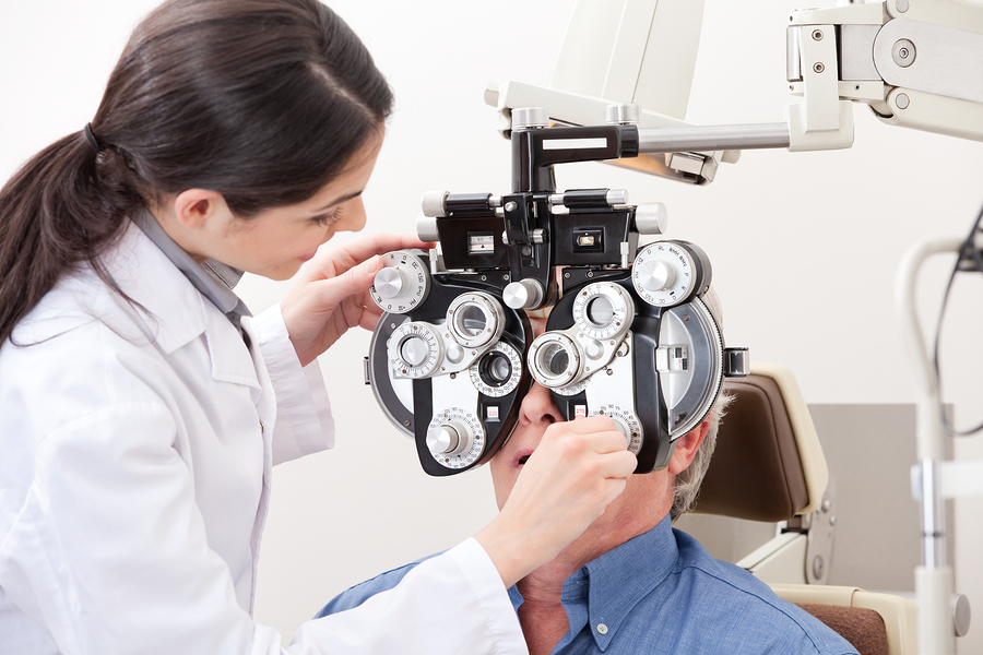 optometrist giving male patient an eye exam in Clarksville